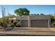 Beautiful home with desert landscaping, a circular driveway, and a two-car garage at 9726 E Hidden Green Dr, Scottsdale, AZ 85262
