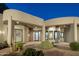 The home's desert landscaping is highlighted by stylish exterior lighting at 9726 E Hidden Green Dr, Scottsdale, AZ 85262