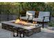 Outdoor fire pit with comfortable seating, decorative lighting, and coffee with snacks in backyard patio at 9726 E Hidden Green Dr, Scottsdale, AZ 85262