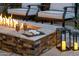 Cozy fire pit with lounge chairs, coffee, snacks, ambient lighting, and inviting backyard patio at 9726 E Hidden Green Dr, Scottsdale, AZ 85262