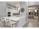 Bright, modern kitchen with white cabinetry, marble countertops, and stainless steel appliances at 9726 E Hidden Green Dr, Scottsdale, AZ 85262