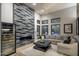 Open-concept living area with fireplace feature wall and walls of windows at 9726 E Hidden Green Dr, Scottsdale, AZ 85262