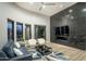Spacious living room with modern fireplace, sleek tile accent wall, and designer furnishings at 9726 E Hidden Green Dr, Scottsdale, AZ 85262