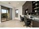 Bright home office featuring built-in desks, cabinetry, and a large window offering natural light and views at 9726 E Hidden Green Dr, Scottsdale, AZ 85262