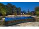 Backyard oasis with pool, water feature, desert landscaping, and lounge chairs at dusk with blue sky at 9726 E Hidden Green Dr, Scottsdale, AZ 85262