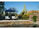 Relaxing pool area with lounge chairs, waterfall feature, desert landscape, and view of multi-story house at 9726 E Hidden Green Dr, Scottsdale, AZ 85262