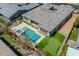 Aerial view showcasing a backyard oasis with pool, putting green and landscaped yard at 9903 E Rotation Dr, Mesa, AZ 85212
