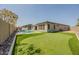 Expansive backyard featuring a pool, spa, putting green, and landscaped areas at 9903 E Rotation Dr, Mesa, AZ 85212