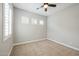 Cozy bedroom with neutral carpet, shuttered windows and a ceiling fan at 9903 E Rotation Dr, Mesa, AZ 85212