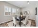 Elegant dining room with large windows, stylish chairs, and sophisticated decor at 9903 E Rotation Dr, Mesa, AZ 85212