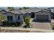 Charming single-story home with a beautiful tile roof, landscaping, and brick driveway at 9903 E Rotation Dr, Mesa, AZ 85212