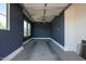 Single car garage with painted blue-grey walls, natural light and room for storage at 9903 E Rotation Dr, Mesa, AZ 85212