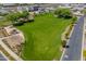Open green space area with grass, trees, walking path and shade structure at 9903 E Rotation Dr, Mesa, AZ 85212