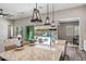 Open concept kitchen with views of the pool, large island, granite counters, and modern pendant lighting at 9903 E Rotation Dr, Mesa, AZ 85212