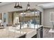 Island with white granite counters and farmhouse sink overlooking covered patio and backyard pool area at 9903 E Rotation Dr, Mesa, AZ 85212
