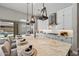 Spacious kitchen with an island, white granite counters, pendant lighting, and stainless steel appliances at 9903 E Rotation Dr, Mesa, AZ 85212
