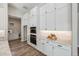 Modern kitchen featuring white cabinetry, granite counters, stainless steel appliances, and hardwood floors at 9903 E Rotation Dr, Mesa, AZ 85212