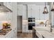 Bright kitchen featuring white cabinetry, stainless steel appliances, and granite countertops at 9903 E Rotation Dr, Mesa, AZ 85212