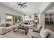 Spacious living room open to the kitchen with modern décor and ample seating at 9903 E Rotation Dr, Mesa, AZ 85212