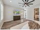 Open main bedroom features wood floors, neutral walls and a large dresser with mounted television at 9903 E Rotation Dr, Mesa, AZ 85212
