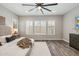 Spacious main bedroom featuring wood floors and three large windows with plantation shutters at 9903 E Rotation Dr, Mesa, AZ 85212