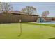 Beautiful putting green alongside a luxurious pool at 9903 E Rotation Dr, Mesa, AZ 85212
