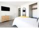 Well-lit bedroom featuring modern décor, a mounted television, and closet at 3907 E Marilyn Rd, Phoenix, AZ 85032