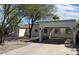 Single-story home featuring a covered carport and drought-resistant landscaping, perfect for low-maintenance living at 3907 E Marilyn Rd, Phoenix, AZ 85032