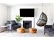 Bright living room features fireplace, mounted television, and hanging chair at 3907 E Marilyn Rd, Phoenix, AZ 85032