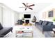 Spacious living room with comfortable seating, fireplace, and ceiling fan at 3907 E Marilyn Rd, Phoenix, AZ 85032
