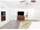 Bright main bedroom with television, ceiling fan, and plush carpet at 3907 E Marilyn Rd, Phoenix, AZ 85032
