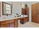 Bright bathroom featuring double sinks, light countertops, and dark wood cabinets at 8625 E Camino Vivaz --, Scottsdale, AZ 85255