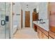 Bright bathroom featuring a soaking tub, walk-in shower, double sinks, and wood accents at 8625 E Camino Vivaz --, Scottsdale, AZ 85255