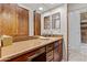 This bathroom features wood cabinets, a large mirror, and granite countertops providing an elegant design at 8625 E Camino Vivaz --, Scottsdale, AZ 85255
