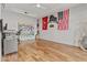 Spacious bedroom with wood floors, painted gray walls, decorative flags and a ceiling fan at 8625 E Camino Vivaz --, Scottsdale, AZ 85255