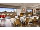 Elegant dining room with an amazing view, tables with white tablecloths, and a grand piano at 8625 E Camino Vivaz --, Scottsdale, AZ 85255