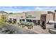 Shopping center exterior with ample parking, outdoor seating, and well-maintained landscaping at 8625 E Camino Vivaz --, Scottsdale, AZ 85255