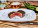 Steakhouse plate featuring a perfectly cooked Filet Mignon cut in half on a bed of garnish at 8625 E Camino Vivaz --, Scottsdale, AZ 85255