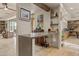 Open living space with bar, seamlessly connecting kitchen, living, and dining areas at 8625 E Camino Vivaz --, Scottsdale, AZ 85255