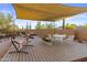 Covered patio with dining set, hammock, desert landscaping, and stylish shade covering at 8625 E Camino Vivaz --, Scottsdale, AZ 85255