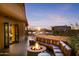Inviting outdoor patio featuring a cozy fire pit and comfortable seating, perfect for enjoying scenic views at 8625 E Camino Vivaz --, Scottsdale, AZ 85255
