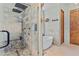 Stylish walk-in shower with stone pebble base and view of the soaking tub at 8625 E Camino Vivaz --, Scottsdale, AZ 85255