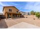 Backyard view of two-story home featuring desert landscaping and covered patio at 1096 E Rolls E Rd, San Tan Valley, AZ 85143