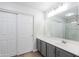Bright bathroom featuring modern vanity with gray cabinets, a large mirror, and a shower over the bathtub at 1096 E Rolls E Rd, San Tan Valley, AZ 85143