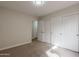 Cozy bedroom featuring neutral colored walls and carpet with built in closets, bathed in soft, natural light at 1096 E Rolls E Rd, San Tan Valley, AZ 85143