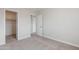 An empty bedroom featuring neutral carpeting and a doorway leading to an adjacent closet at 1096 E Rolls E Rd, San Tan Valley, AZ 85143