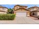 Two-story home featuring a white garage door and neutral color scheme, complemented by a well-maintained lawn at 1096 E Rolls E Rd, San Tan Valley, AZ 85143