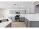 Well-lit kitchen featuring gray cabinets, quartz countertops, and stainless steel appliances with wood look floors at 1096 E Rolls E Rd, San Tan Valley, AZ 85143