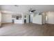 Spacious open floor plan with lots of light and wood floors, seamlessly connects to the kitchen with gray cabinets at 1096 E Rolls E Rd, San Tan Valley, AZ 85143