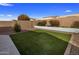 Private backyard featuring artificial turf and block wall fencing at 11148 E Tumbleweed Ave, Mesa, AZ 85212